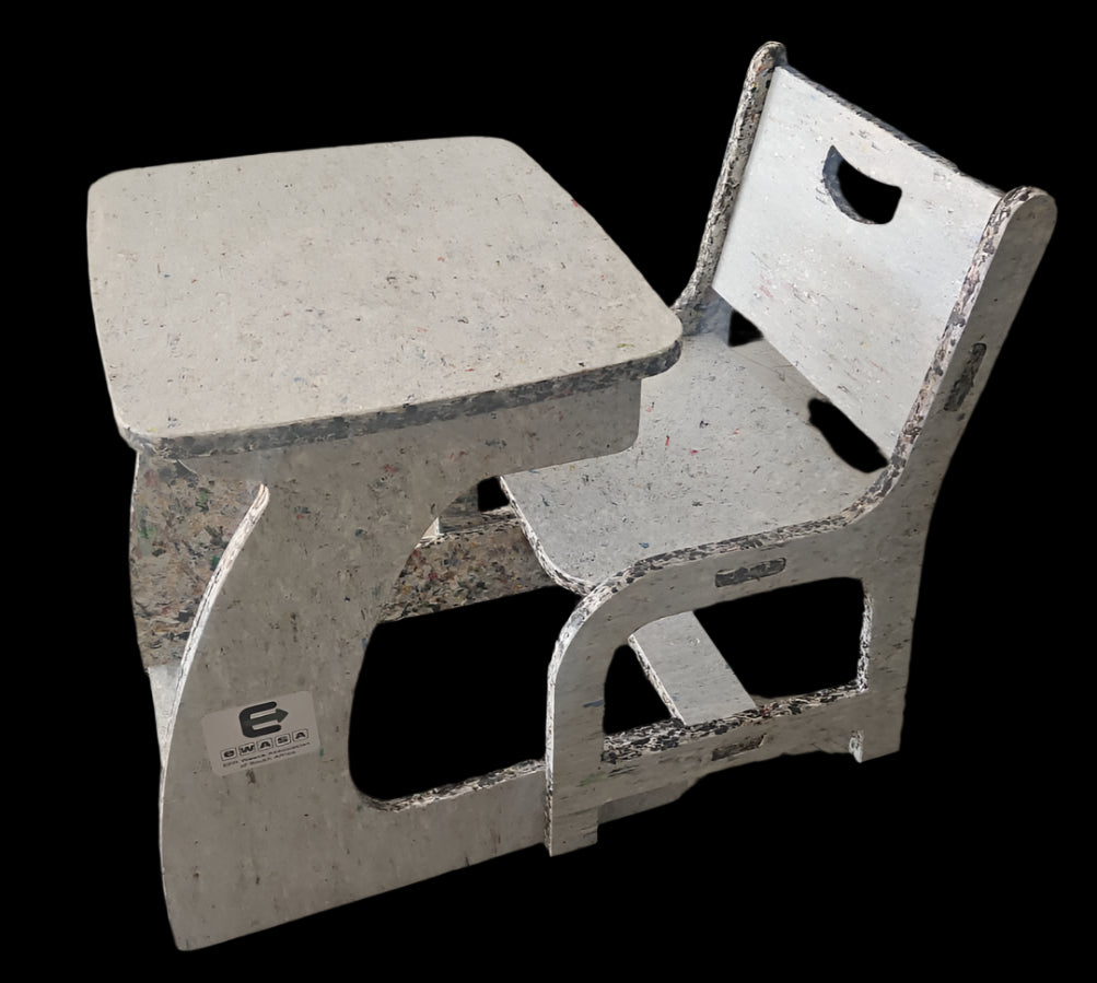 Concrete table and chair set on a concrete floor with a colorful wall in the background.