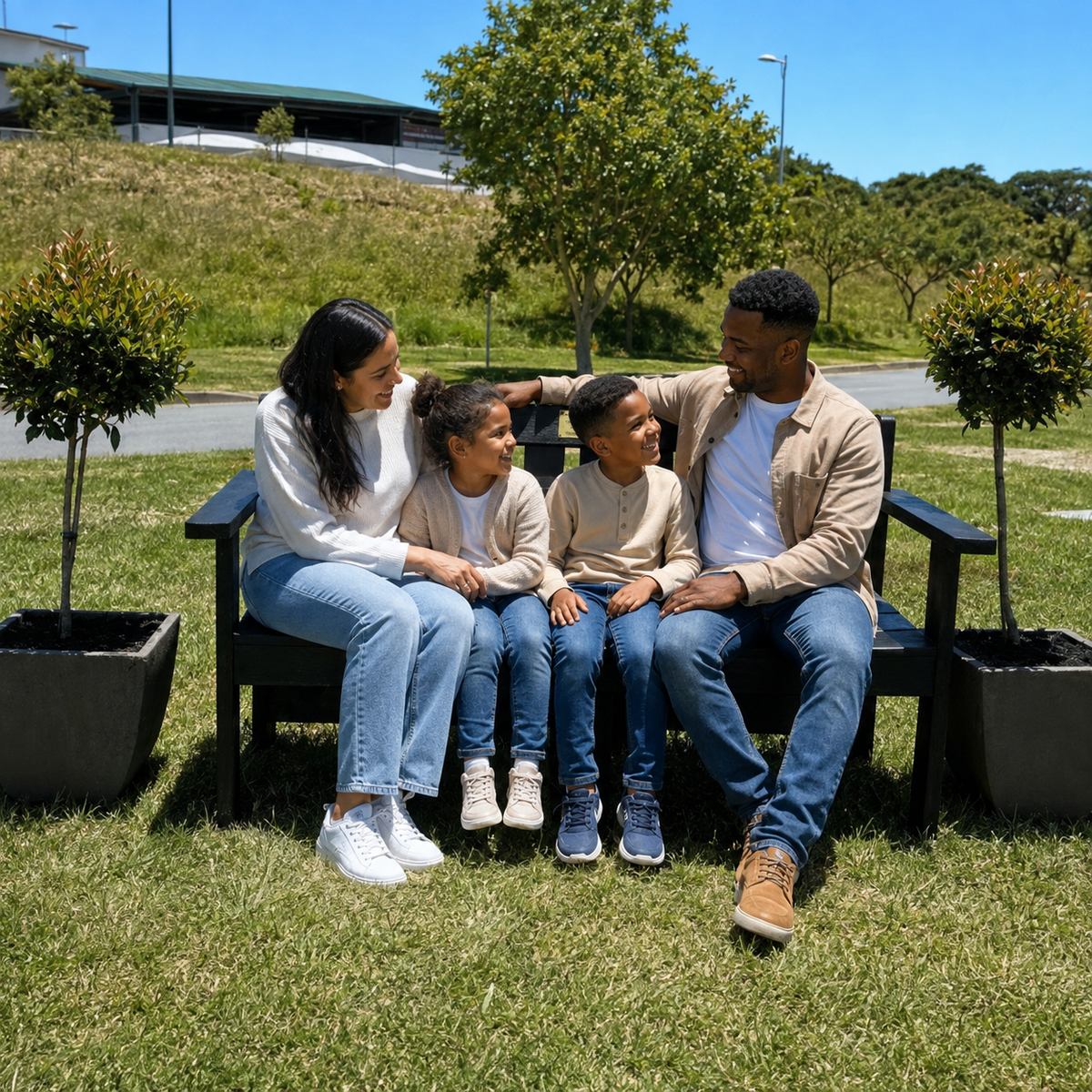 A mixed South African family sharing a conversation on a Royal Bench